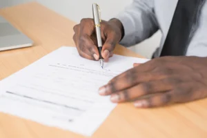 A person signing a document.