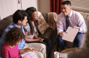 Smiling family reviewing legal documents with a lawyer.